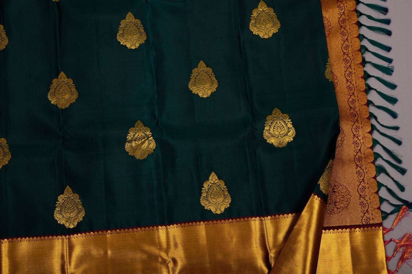 Pure silk Kanchipuram saree in bottle green with maroon colour combination and with beautiful thilagam butta ask seller before placing