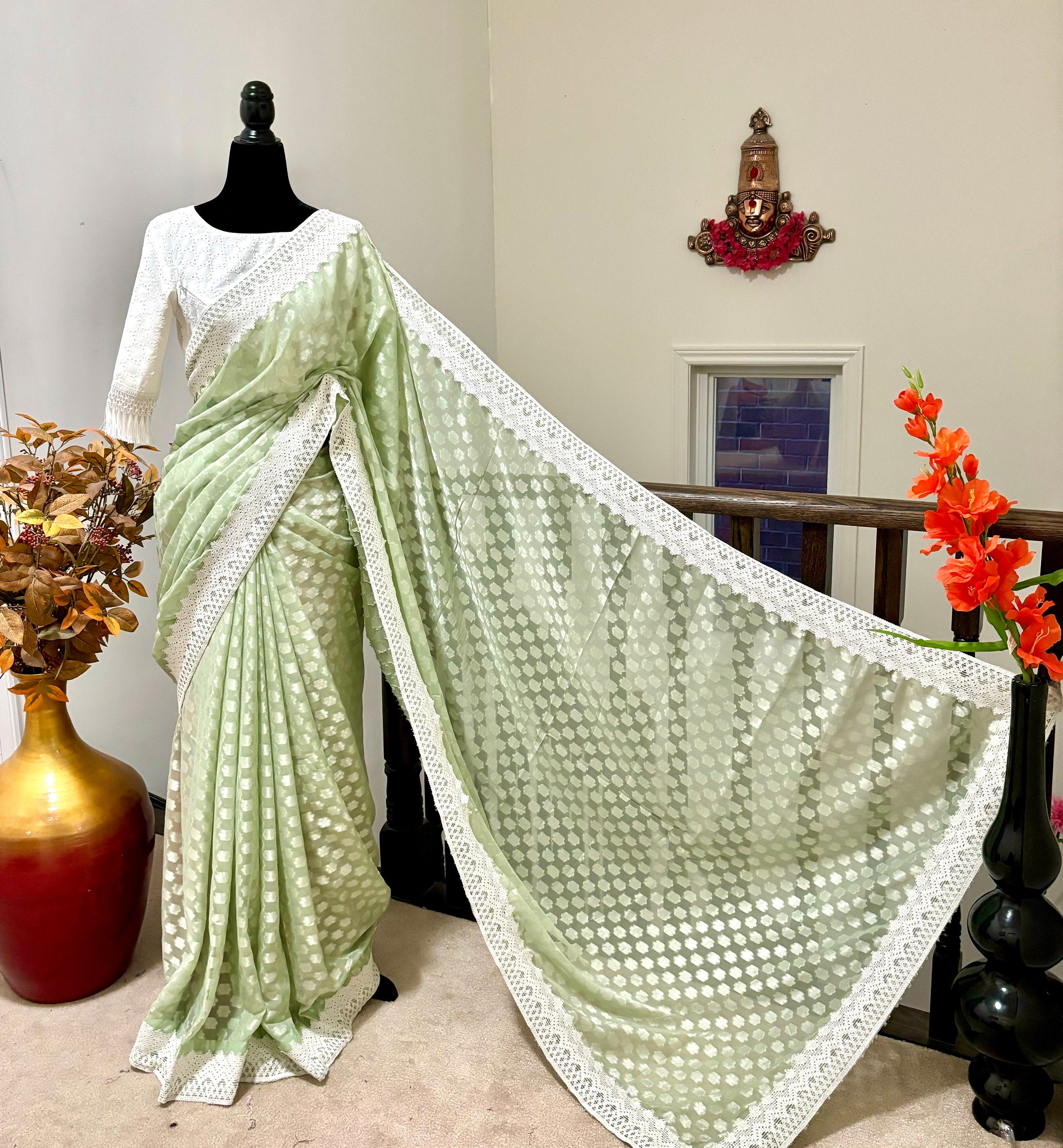 Beautiful soft falling  georgette on  sabyasachi  lace borders unique,  eye cooling pestal shades. Ready to wear designer blouse fits 32-44