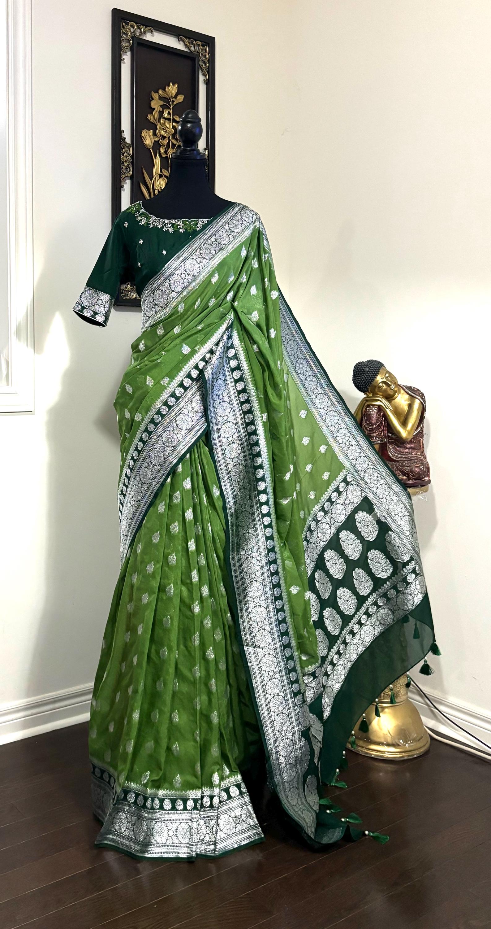 Beautiful banarasi saree paired up with pretty maggam work blouse.dits to 32-46