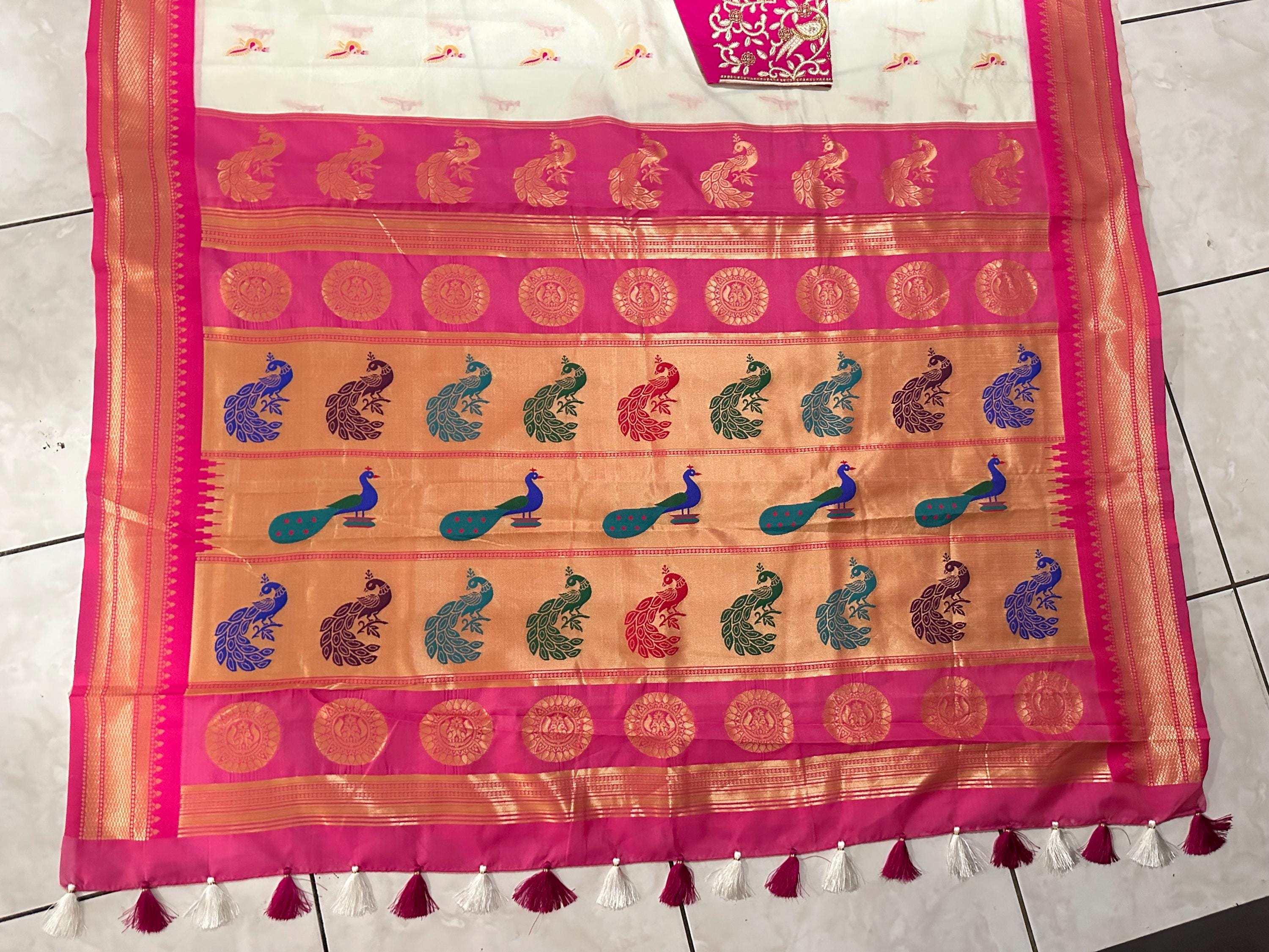 Beautiful soft white and pink paithani silk saree with all over zari weaving along with handwork on blouse