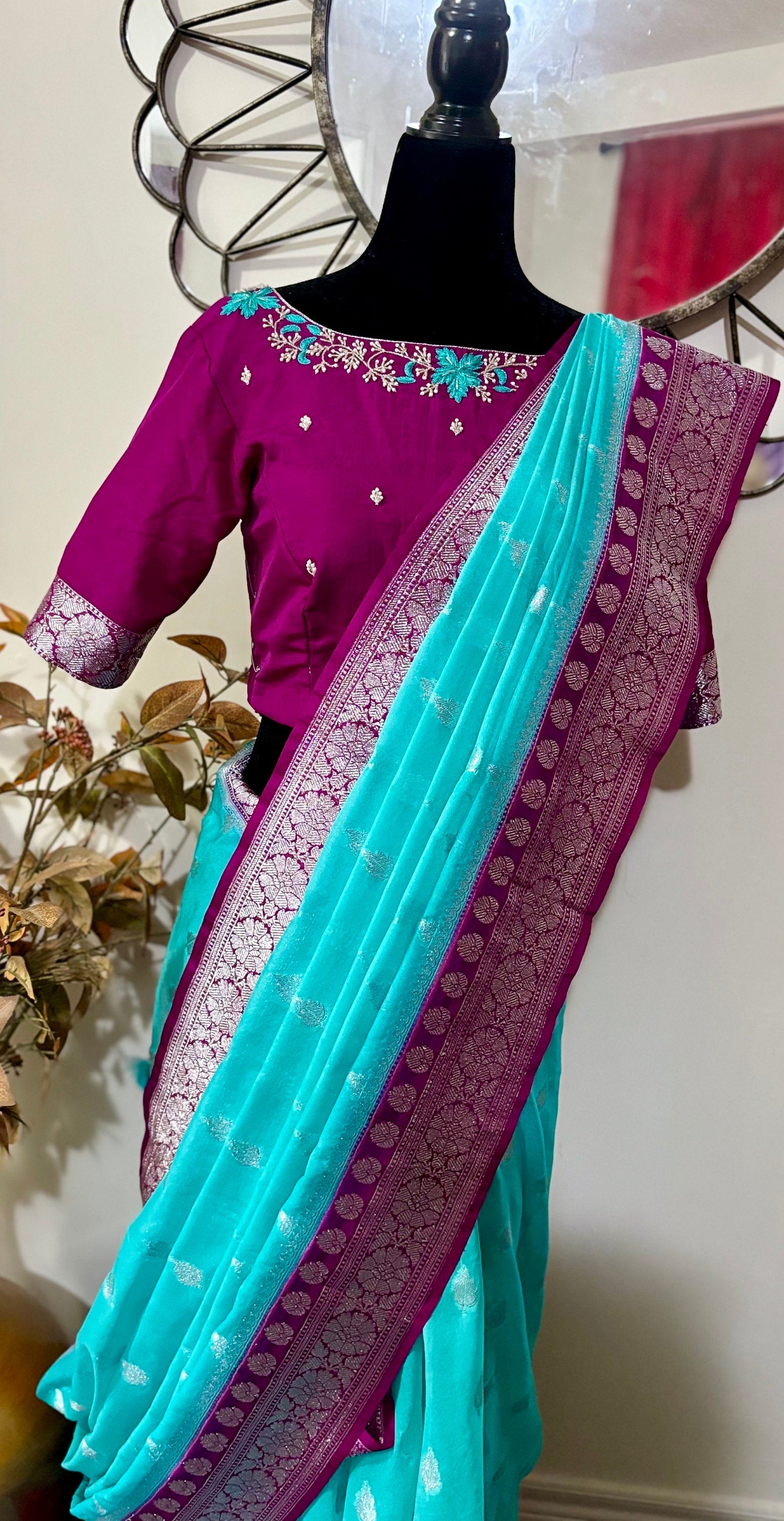 Beautiful banarasi saree paired up with pretty maggam work blouse.