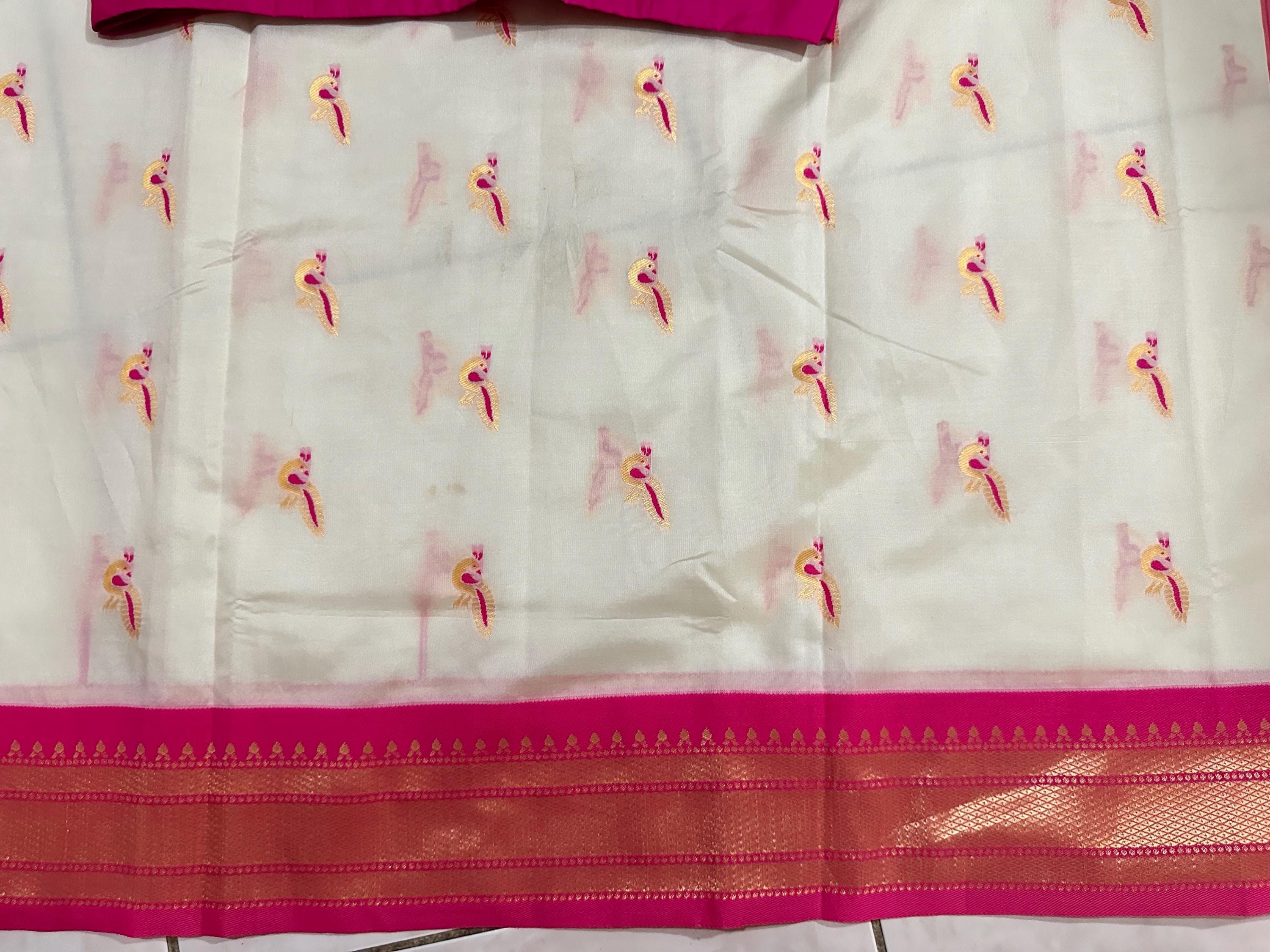 Beautiful soft white and pink paithani silk saree with all over zari weaving along with handwork on blouse