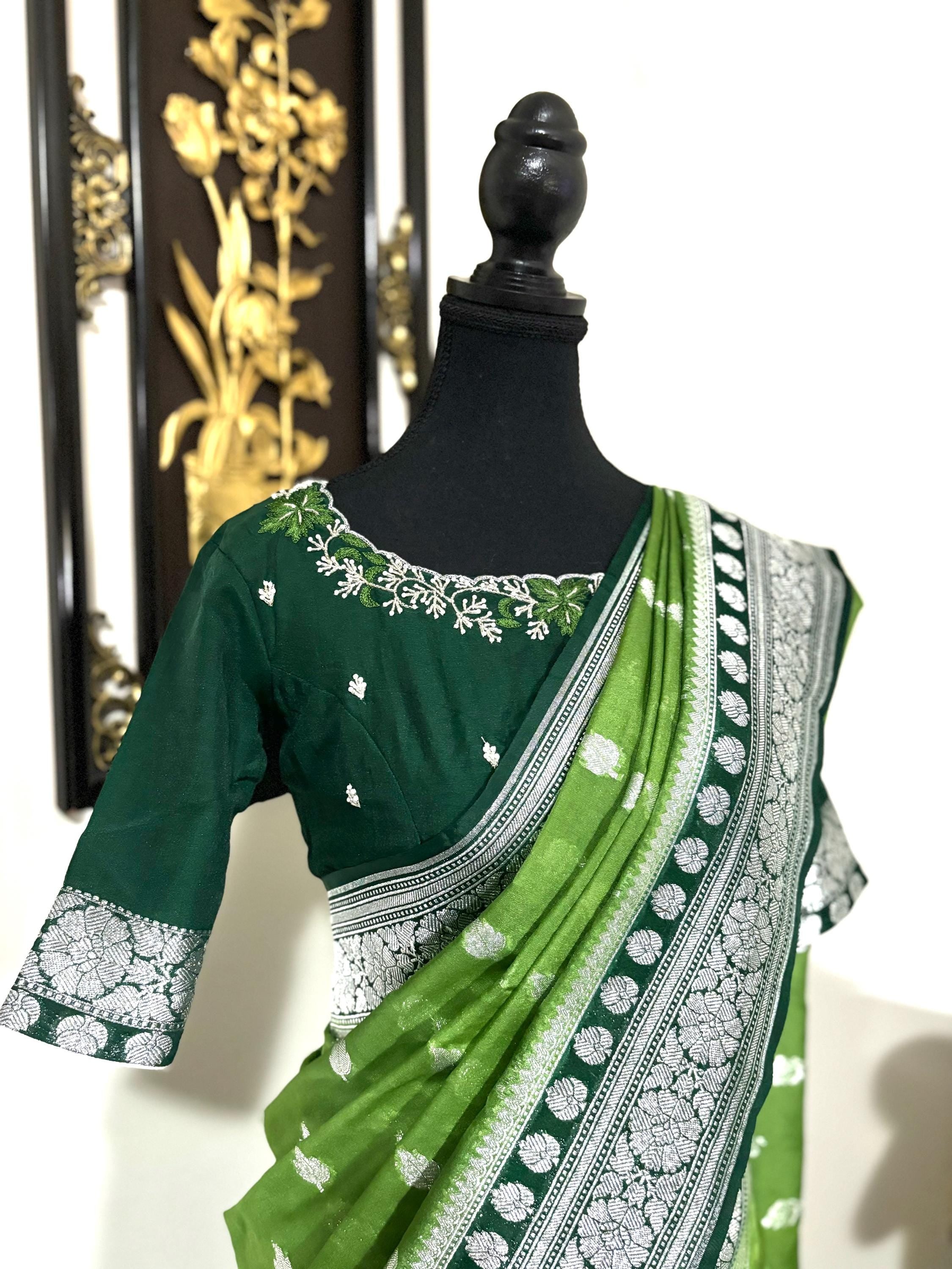 Beautiful banarasi saree paired up with pretty maggam work blouse.dits to 32-46