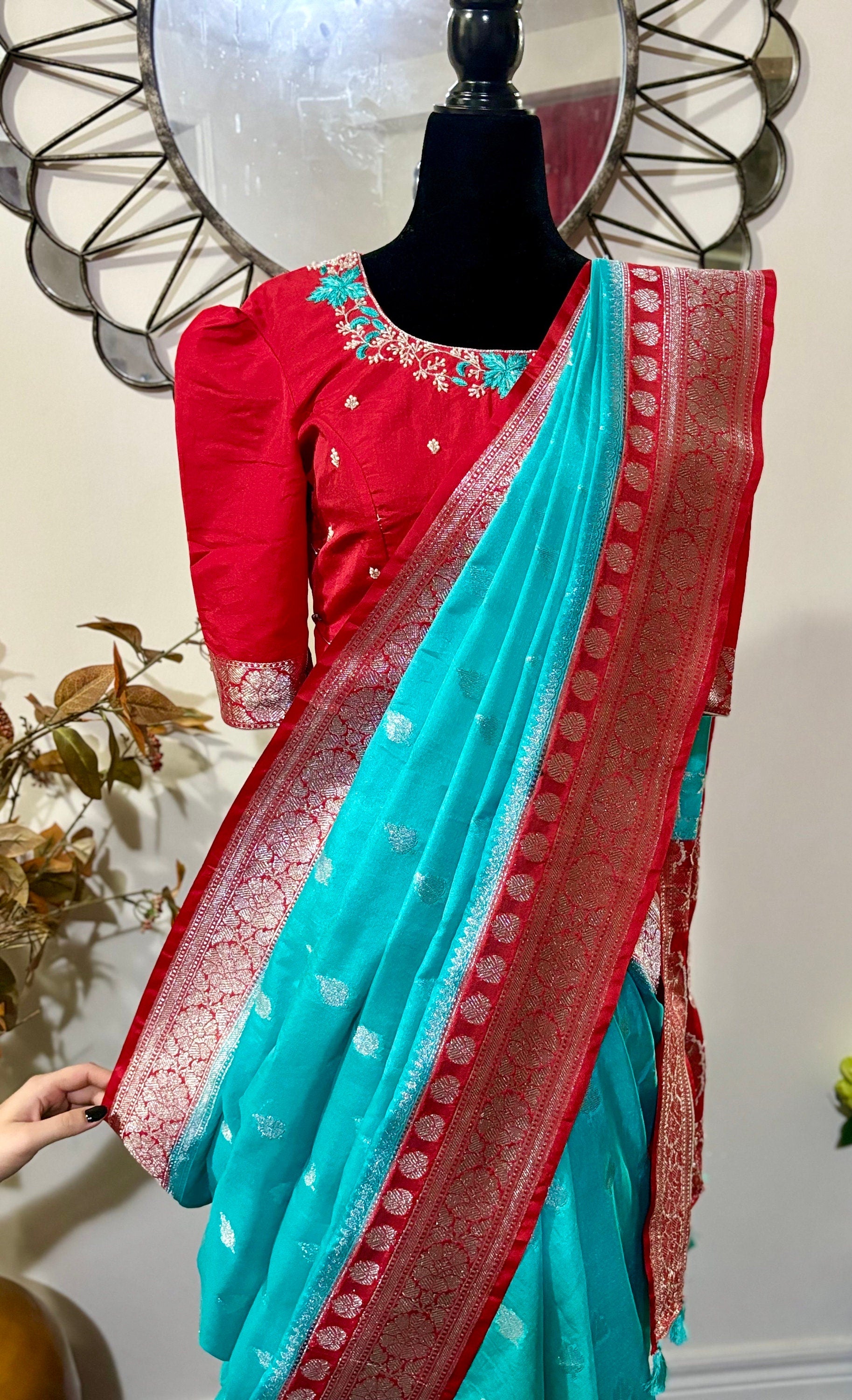 Beautiful banarasi saree paired up with pretty maggam work blouse.