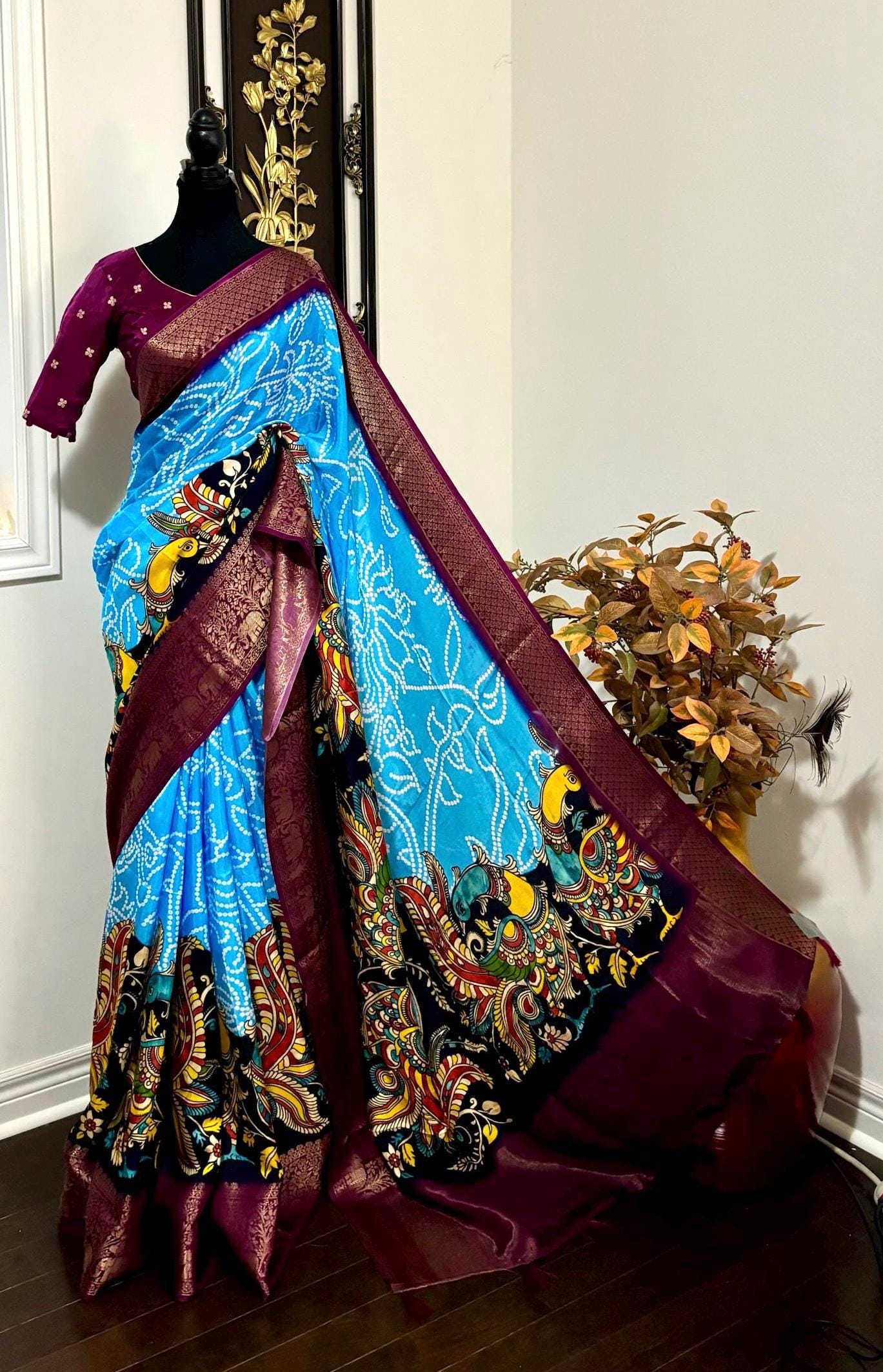 Beautiful pure silk bandini silk saree paired up pretty blouse sizes 32 -46 ready to wear.With Zari boarders elephant prints and peacocks
