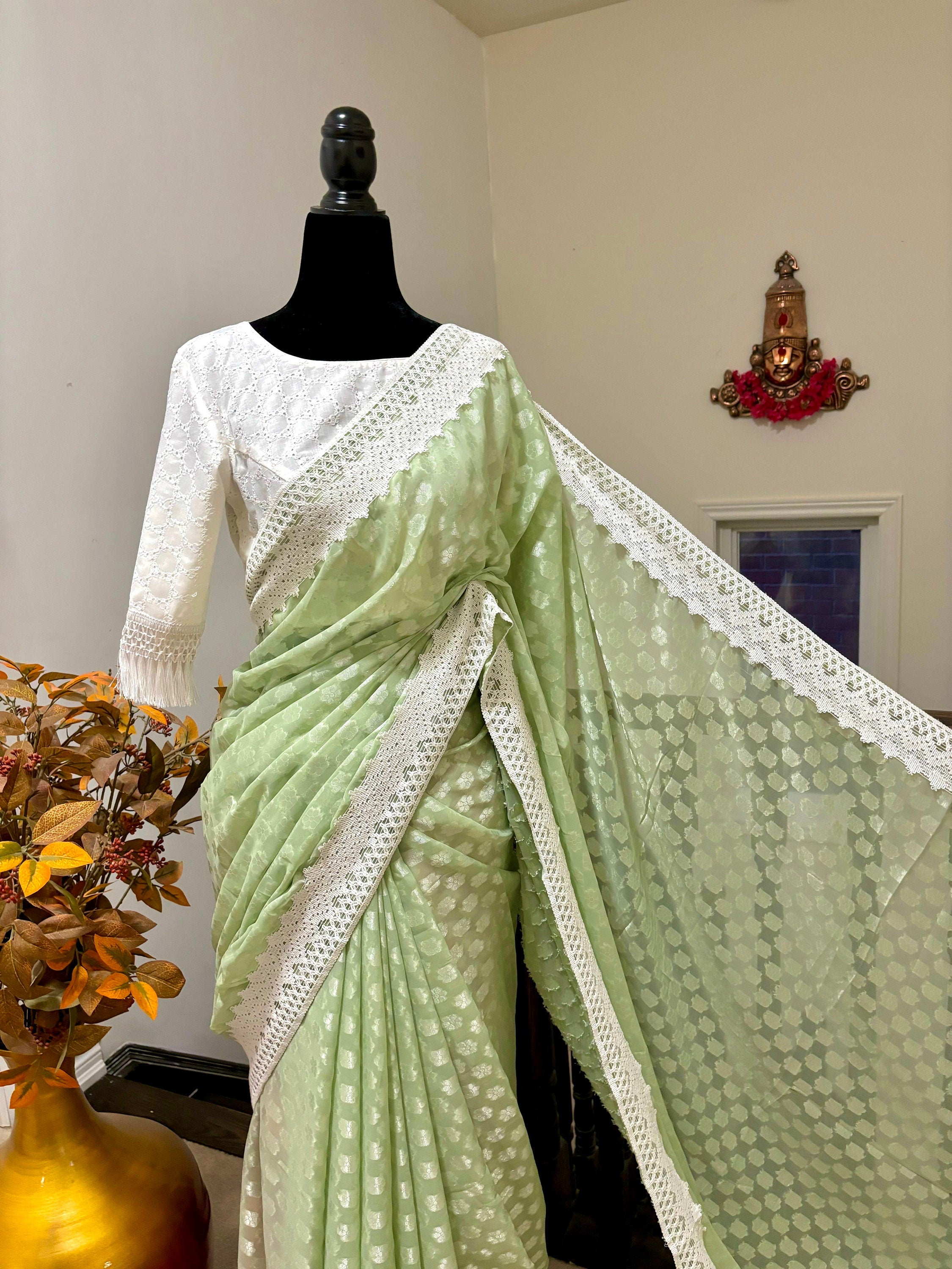 Beautiful soft falling  georgette on  sabyasachi  lace borders unique,  eye cooling pestal shades. Ready to wear designer blouse fits 32-44
