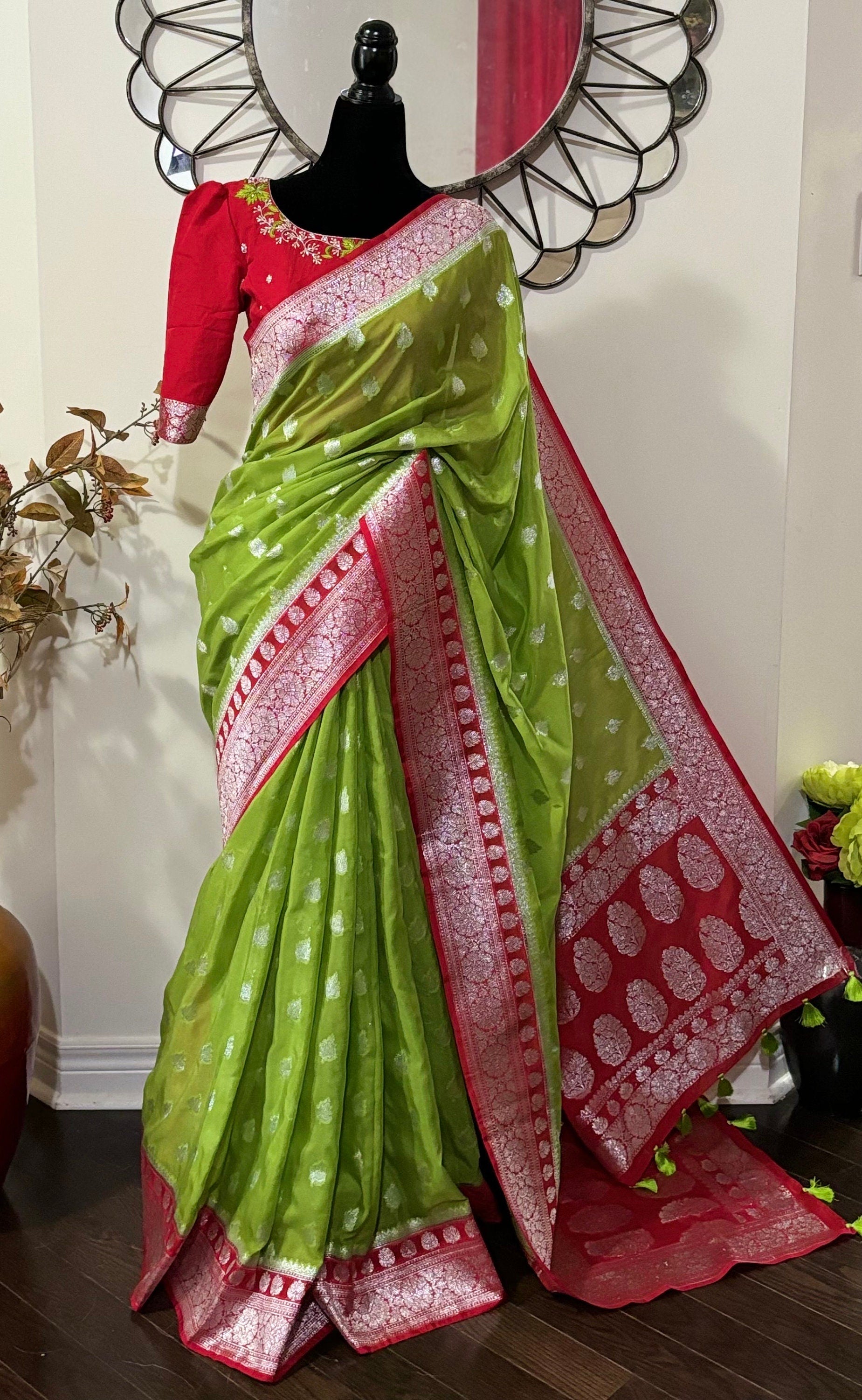 Beautiful banarasi saree paired up with pretty maggam work blouse.