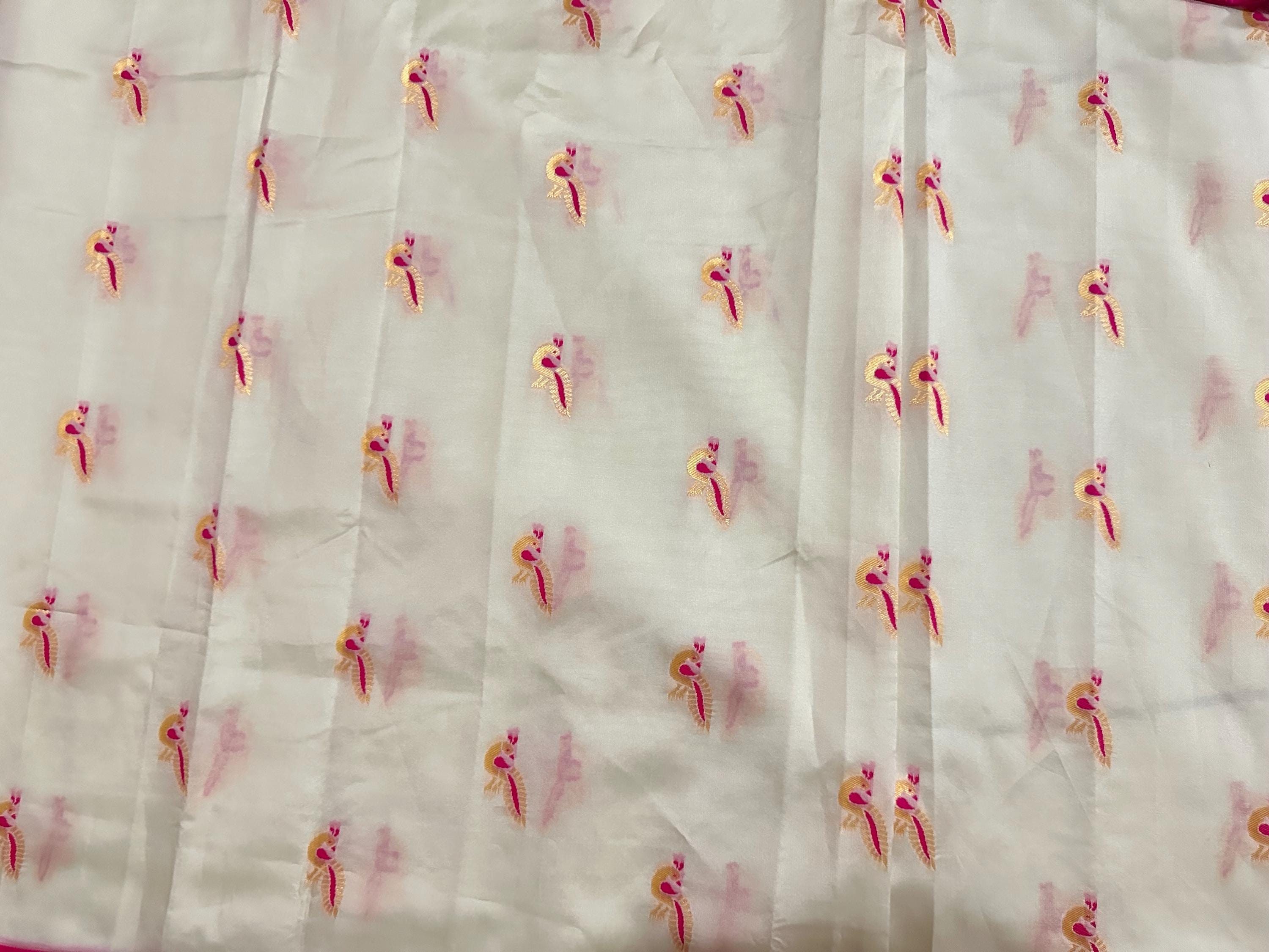 Beautiful soft white and pink paithani silk saree with all over zari weaving along with handwork on blouse