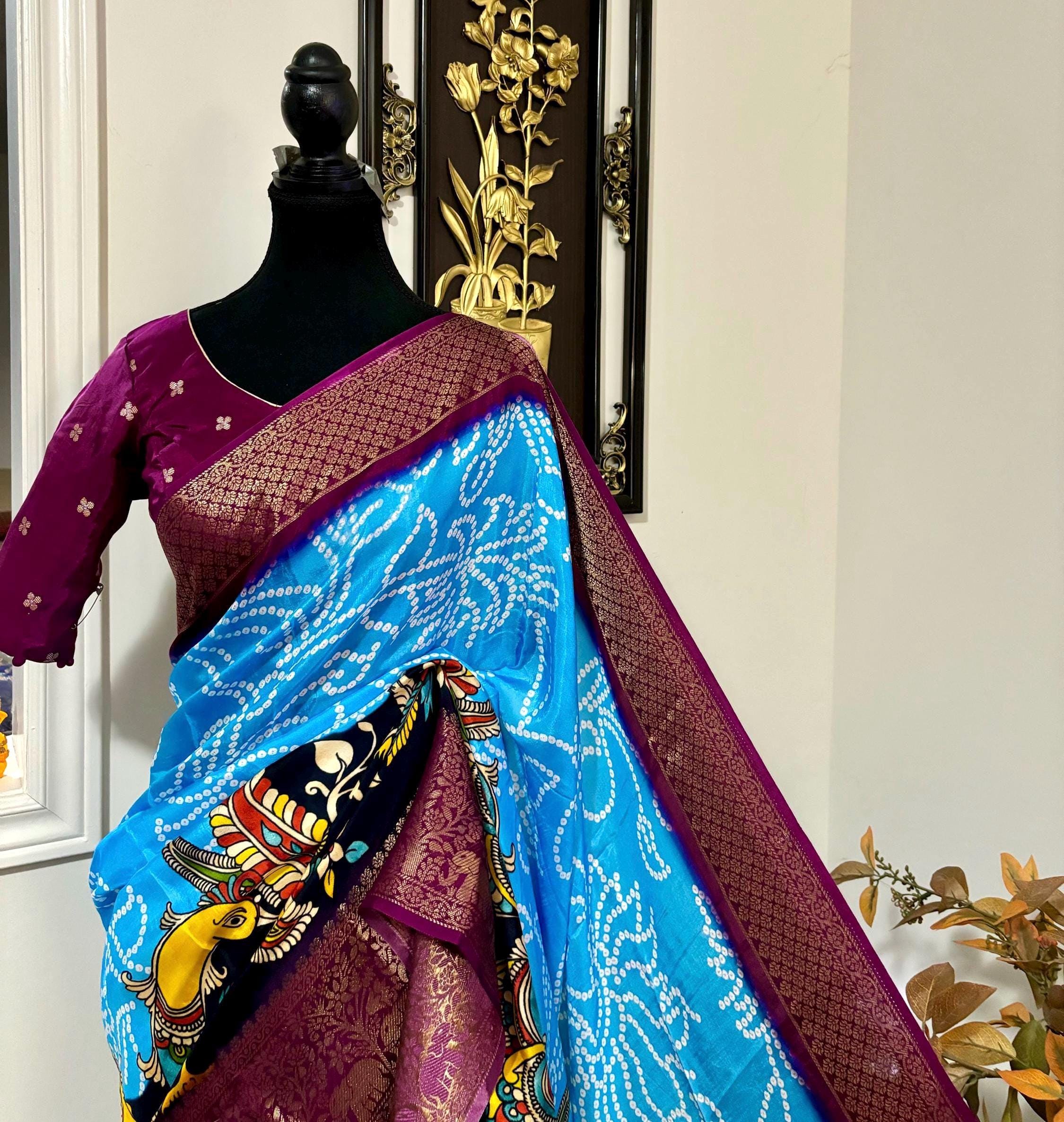 Beautiful pure silk bandini silk saree paired up pretty blouse sizes 32 -46 ready to wear.With Zari boarders elephant prints and peacocks