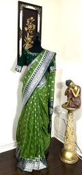 Beautiful banarasi saree paired up with pretty maggam work blouse.dits to 32-46