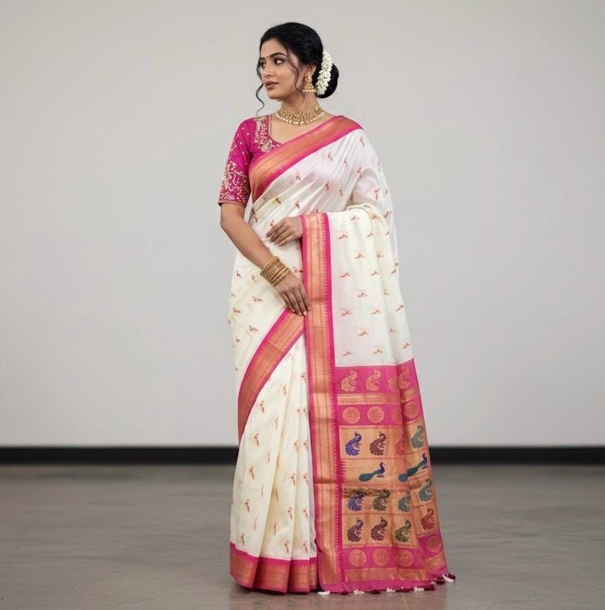 Beautiful soft white and pink paithani silk saree with all over zari weaving along with handwork on blouse