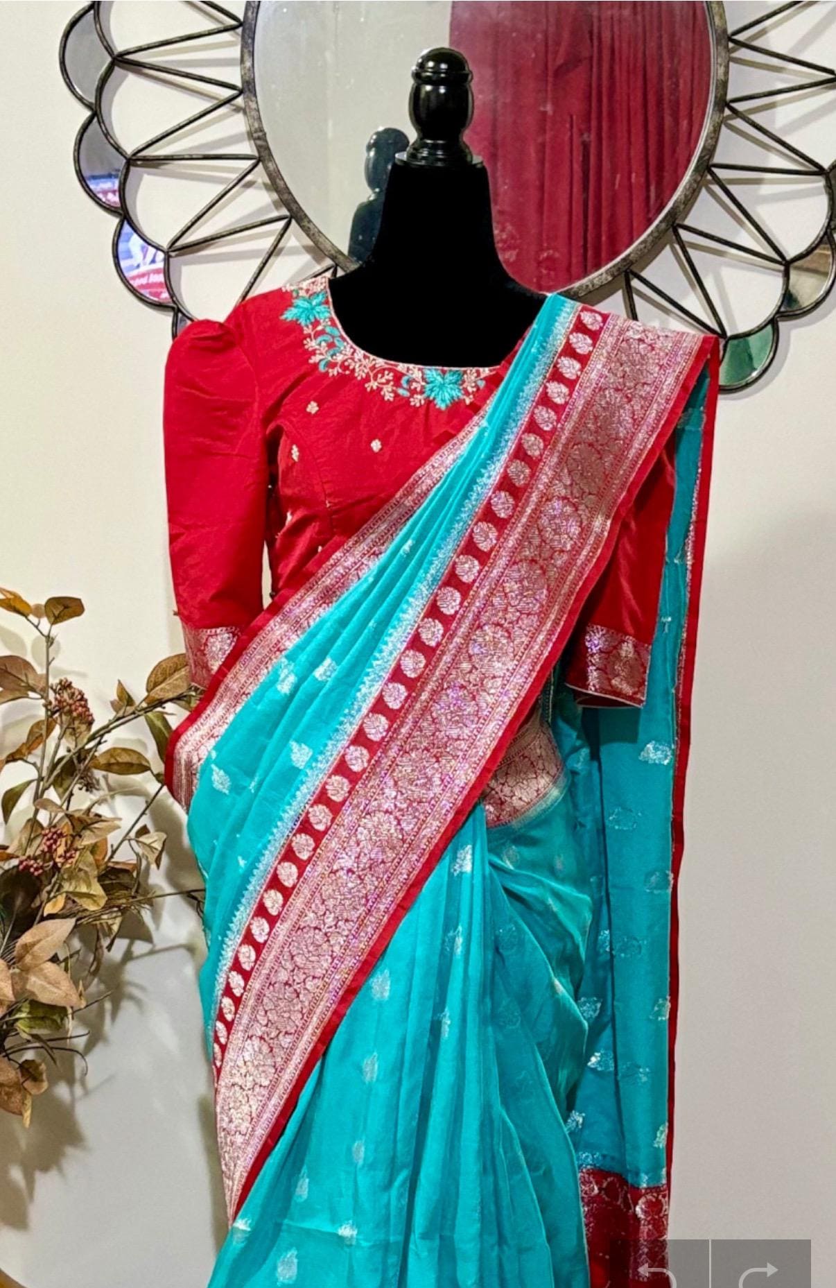 Beautiful banarasi saree paired up with pretty maggam work blouse.